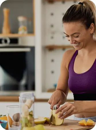 happy athletic woman cutting fruit while preparing healthy meal kitchen
