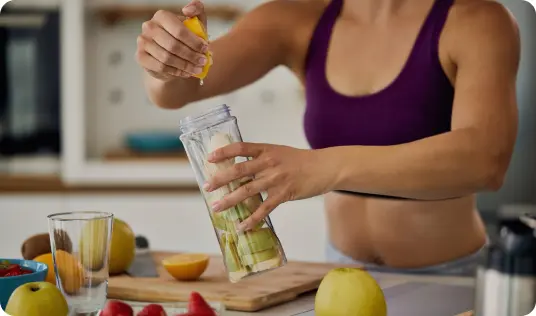 squeezing fresh juice into a glass