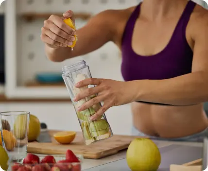 squeezing fresh juice into a glass