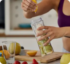 squeezing fresh juice into a glass